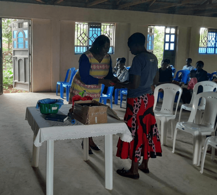 Marysa receives a Bible after a Sunday service